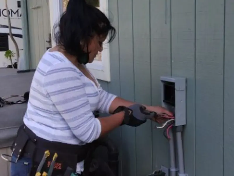 Licensed electrician wiring an exterior subpanel in Hilmar-Irwin